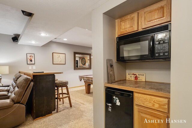 kitchen with black microwave, recessed lighting, light carpet, open floor plan, and baseboards