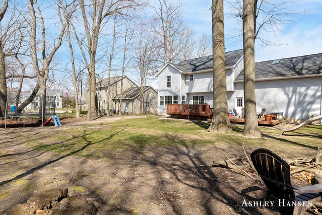 view of yard with a trampoline and a deck