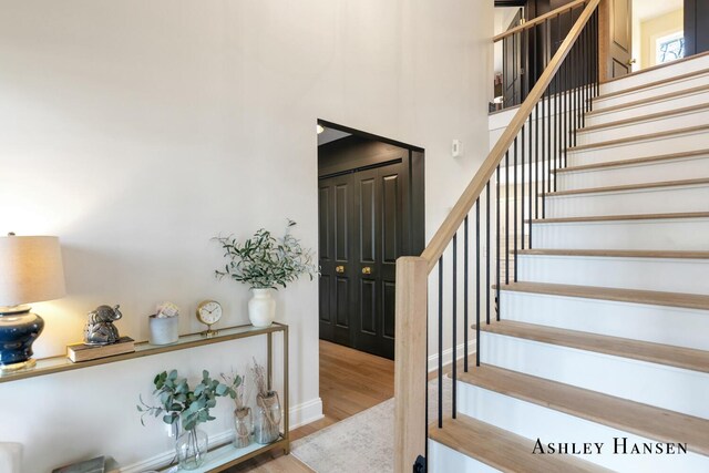 stairs with baseboards and wood finished floors