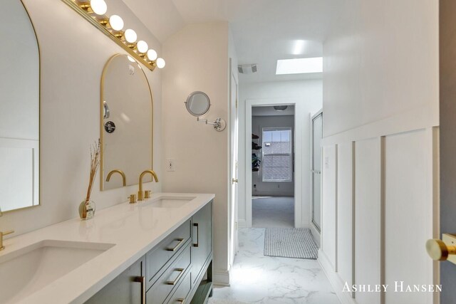 bathroom featuring double vanity, visible vents, marble finish floor, and a sink