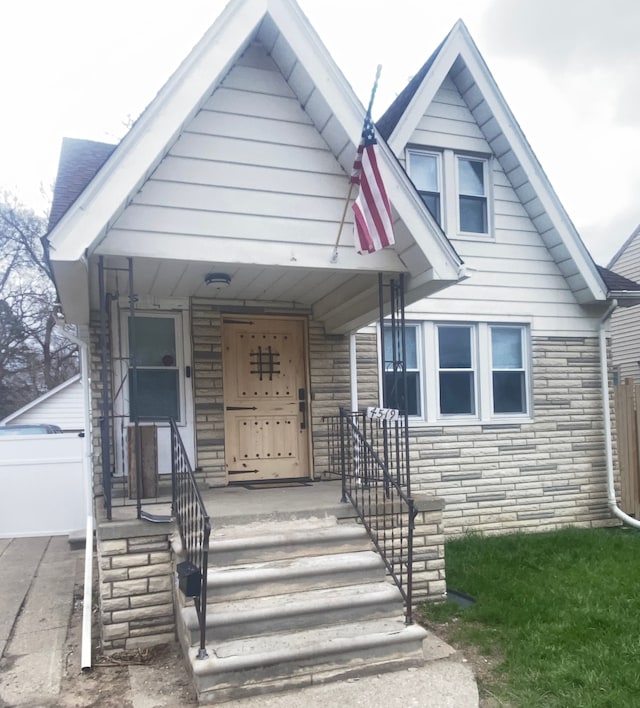 4519 Washington St, Wayne, MI 48184 - bungalow-style home with stone siding, fence, and a garage
