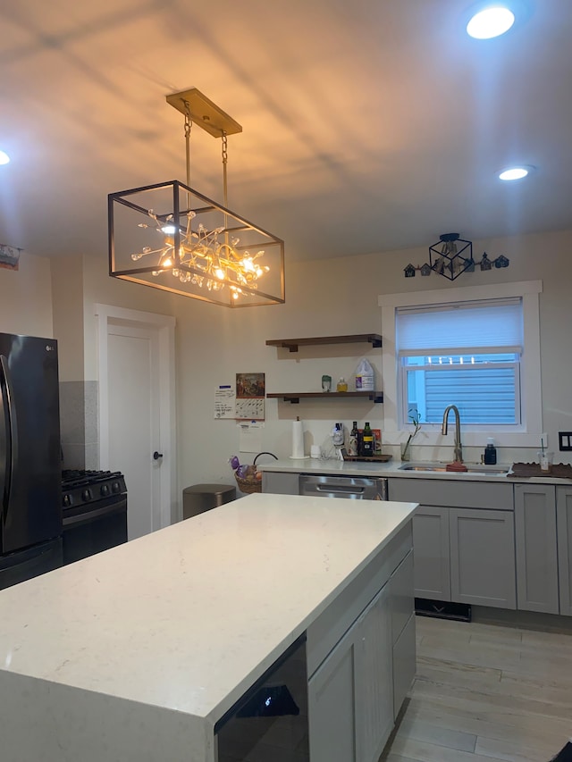 4519 Washington St, Wayne, MI 48184 - kitchen featuring wine cooler, a sink, an inviting chandelier, a kitchen island, and black appliances