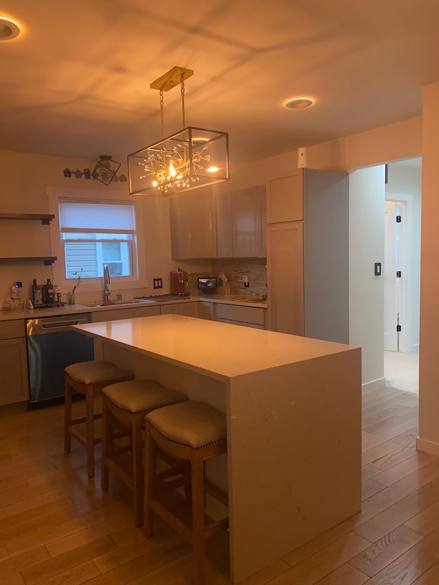 4519 Washington St, Wayne, MI 48184 - kitchen featuring a sink, dishwasher, light wood finished floors, light countertops, and a kitchen island