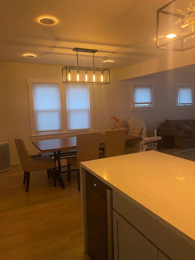 4519 Washington St, Wayne, MI 48184 - kitchen featuring open floor plan, beverage cooler, light wood-style flooring, pendant lighting, and light countertops