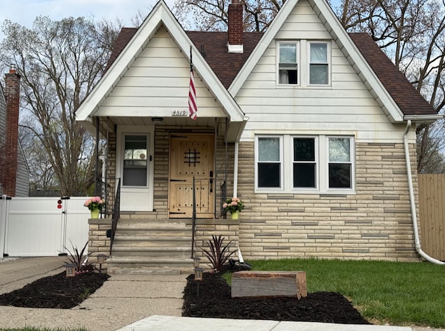 4519 Washington St, Wayne, MI 48184 - bungalow-style house featuring fence, a shingled roof, and a chimney
