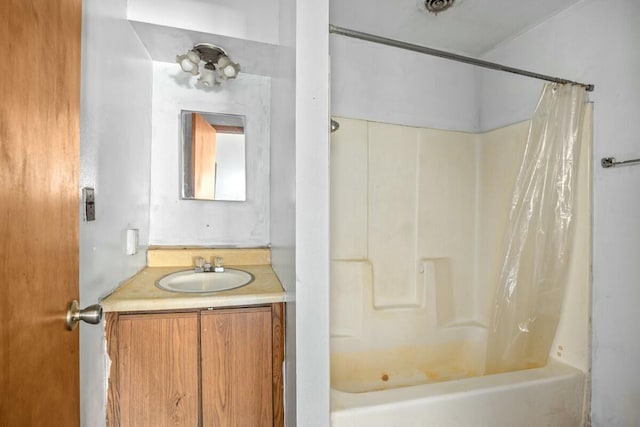 bathroom with shower / bath combo with shower curtain and vanity