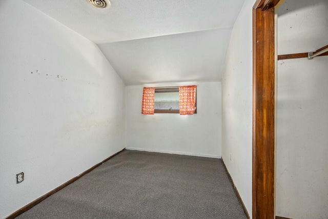 additional living space featuring visible vents, baseboards, carpet, and lofted ceiling
