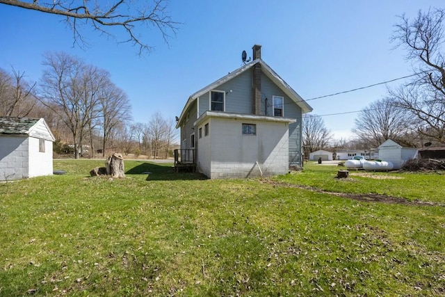 rear view of property with a lawn
