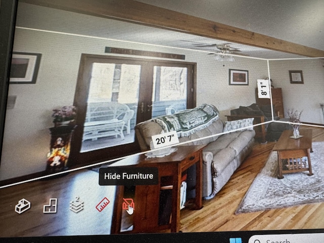 living room featuring ceiling fan, beam ceiling, and wood finished floors