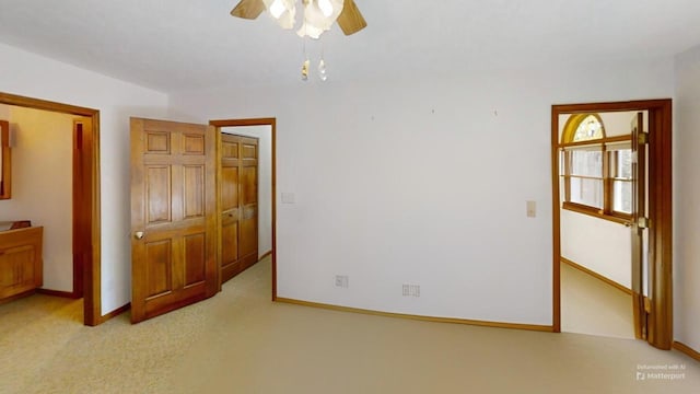 unfurnished bedroom with baseboards, ceiling fan, and light colored carpet