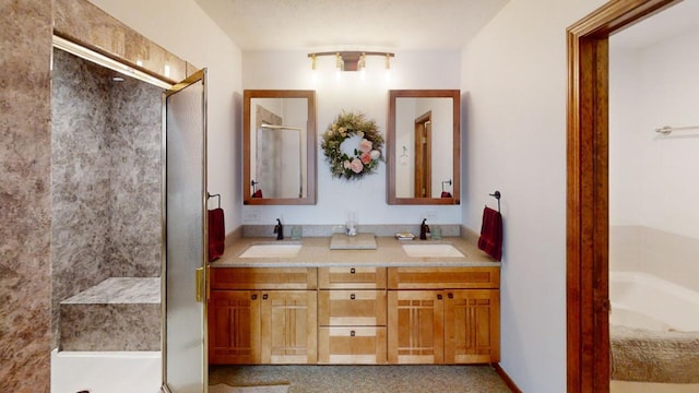 full bathroom featuring double vanity, a tub, a sink, and a stall shower