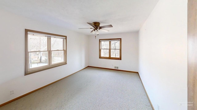 unfurnished room featuring visible vents, baseboards, ceiling fan, and light colored carpet