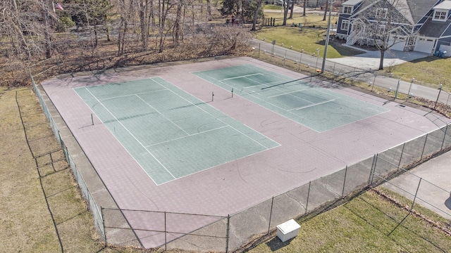exterior space featuring a yard, fence, and community basketball court