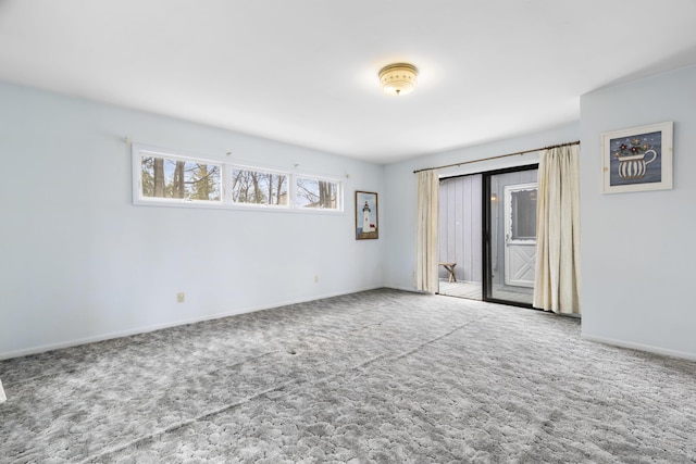 carpeted empty room with baseboards