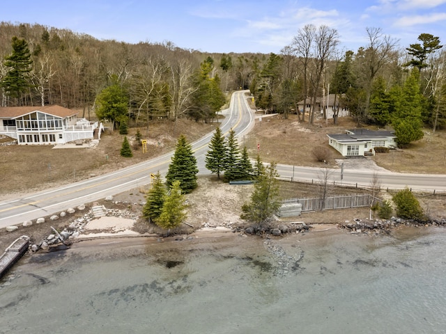 birds eye view of property featuring a view of trees