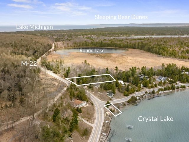 aerial view with a water view and a forest view