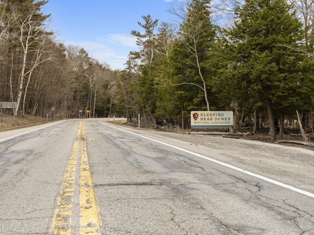 view of road featuring a forest view