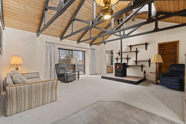 living area featuring wood ceiling, high vaulted ceiling, a wood stove, and carpet floors