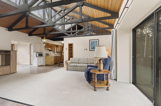 living room featuring light carpet, a high ceiling, and baseboards