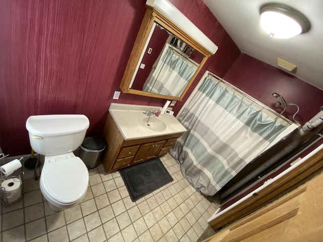 bathroom with tile patterned floors, vanity, and toilet