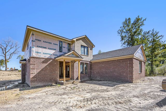 property in mid-construction with brick siding