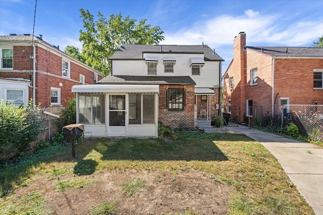 18468 Santa Barbara Dr, Detroit, MI 48221 - rear view of property with brick siding, a fenced backyard, a sunroom, and a lawn