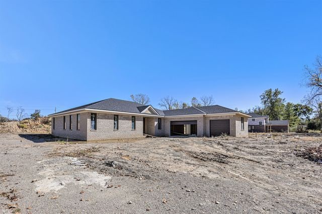 view of front facade featuring a garage and brick siding
