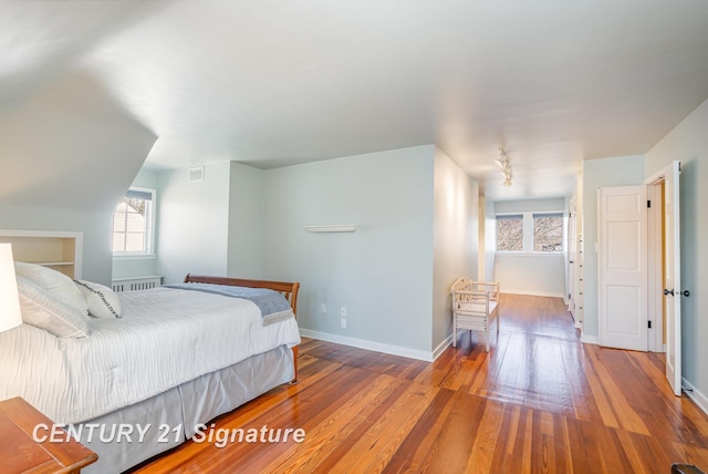 105 Parkwood Ct, Bay City, MI 48706 - bedroom featuring visible vents, wood-type flooring, multiple windows, and baseboards