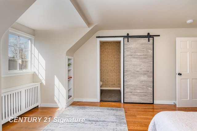 105 Parkwood Ct, Bay City, MI 48706 - bedroom featuring baseboards, radiator, and wood finished floors