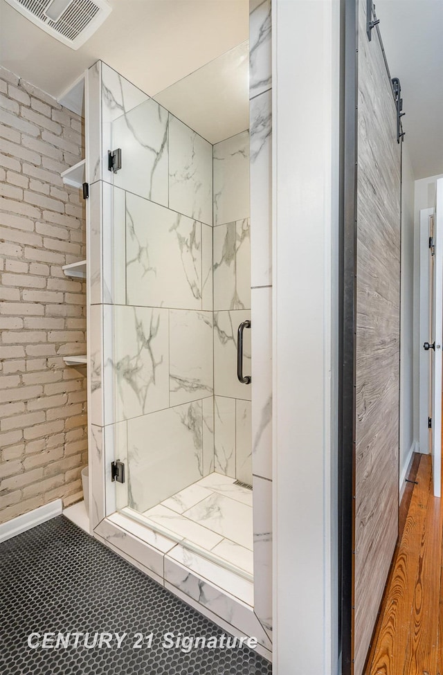 105 Parkwood Ct, Bay City, MI 48706 - bathroom with brick wall, toilet, visible vents, and a stall shower