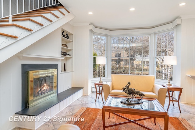 105 Parkwood Ct, Bay City, MI 48706 - living room with ornamental molding, built in shelves, a glass covered fireplace, and recessed lighting