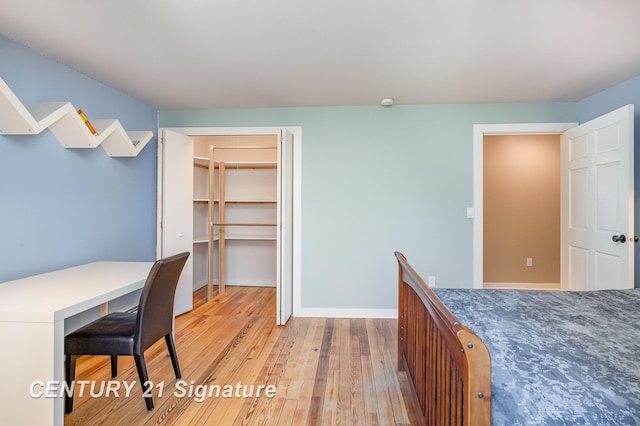 105 Parkwood Ct, Bay City, MI 48706 - unfurnished bedroom featuring a closet, baseboards, and light wood-style floors