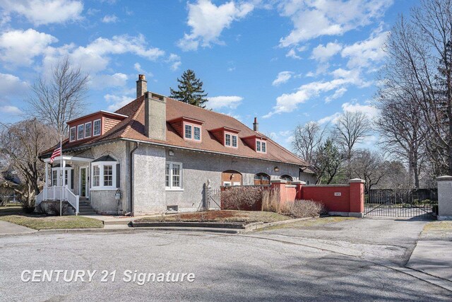 105 Parkwood Ct, Bay City, MI 48706 - exterior space with fence, a chimney, and a gate