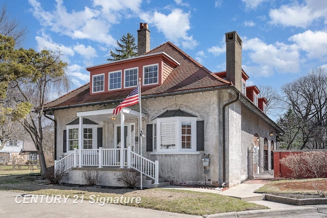 105 Parkwood Ct, Bay City, MI 48706 - view of front facade featuring stucco siding and a chimney