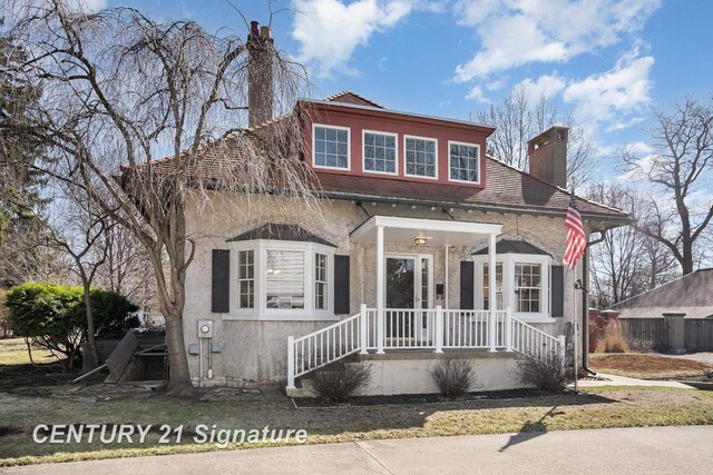 105 Parkwood Ct, Bay City, MI 48706 - view of front of home featuring stucco siding and a chimney