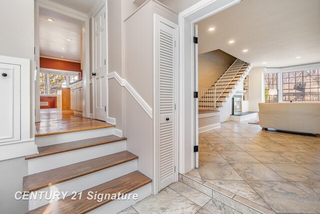 105 Parkwood Ct, Bay City, MI 48706 - stairs featuring recessed lighting, marble finish floor, and ornamental molding