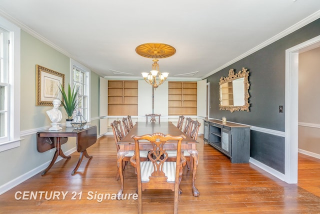 105 Parkwood Ct, Bay City, MI 48706 - dining room with a chandelier, light wood-style flooring, baseboards, and crown molding
