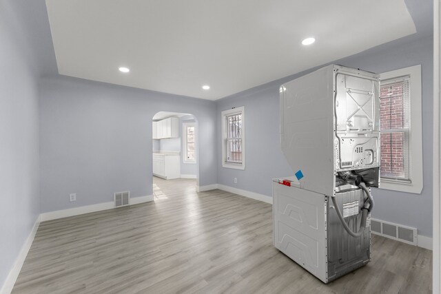 7416 Heyden St, Detroit, MI 48228 - unfurnished office featuring visible vents, light wood-style flooring, arched walkways, and plenty of natural light