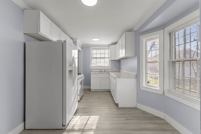 7416 Heyden St, Detroit, MI 48228 - kitchen featuring white cabinets, light countertops, white appliances, and baseboards