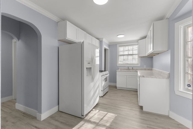 7416 Heyden St, Detroit, MI 48228 - kitchen with crown molding, light countertops, white appliances, and baseboards