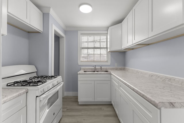 7416 Heyden St, Detroit, MI 48228 - kitchen featuring a sink, white cabinets, white gas range, and light wood-style floors