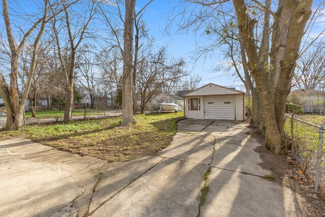 7416 Heyden St, Detroit, MI 48228 - exterior space featuring driveway, a detached garage, fence, and an outdoor structure