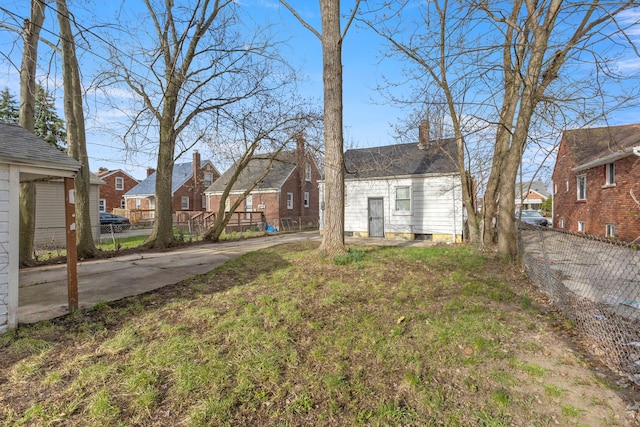 7416 Heyden St, Detroit, MI 48228 - view of yard with concrete driveway, a residential view, and fence