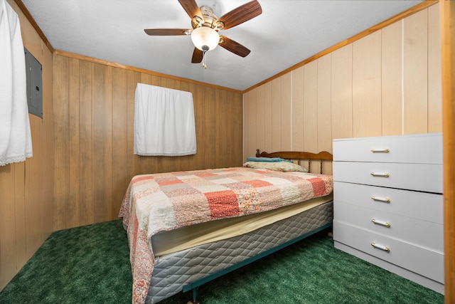 carpeted bedroom featuring wooden walls, ornamental molding, ceiling fan, and electric panel