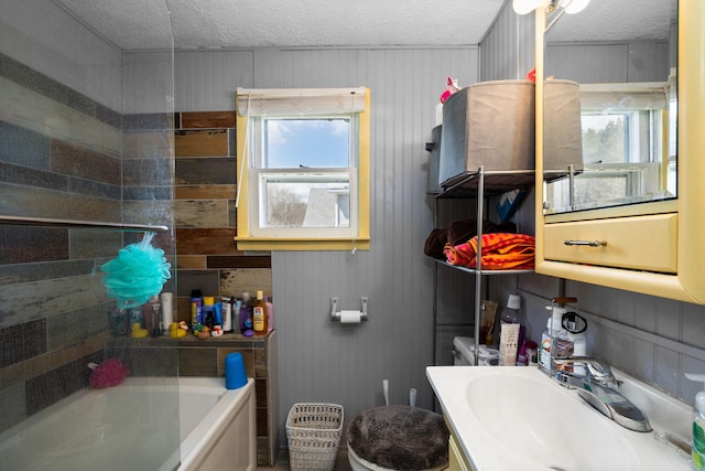 full bath featuring toilet, a textured ceiling, and vanity
