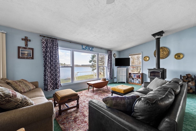 living area with a wood stove, carpet, a textured ceiling, and vaulted ceiling