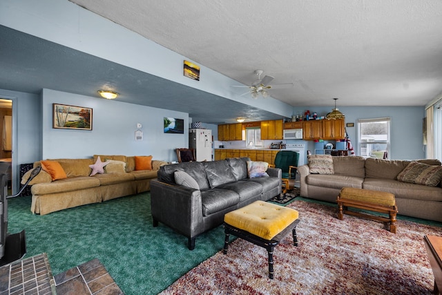 living room featuring dark colored carpet, a textured ceiling, and ceiling fan
