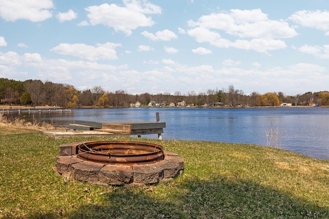 water view featuring a wooded view and a fire pit