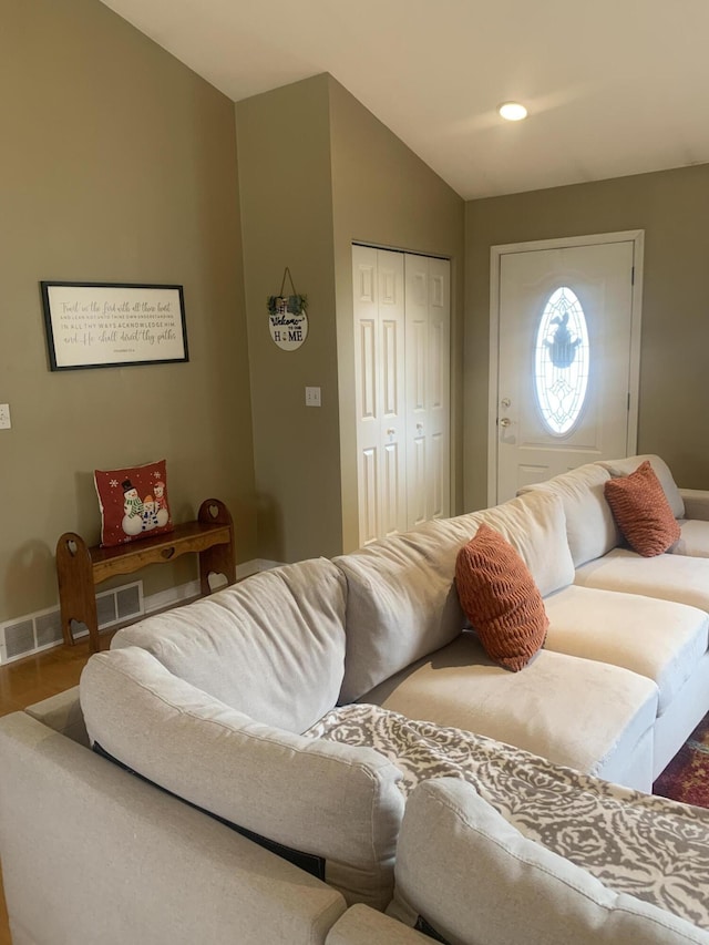 133 Bingham Dr, Brooklyn, MI 49230 - living area featuring baseboards, wood finished floors, and vaulted ceiling