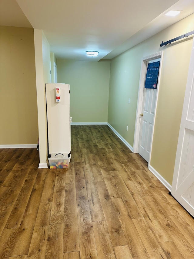 133 Bingham Dr, Brooklyn, MI 49230 - basement with wood finished floors, baseboards, and a barn door